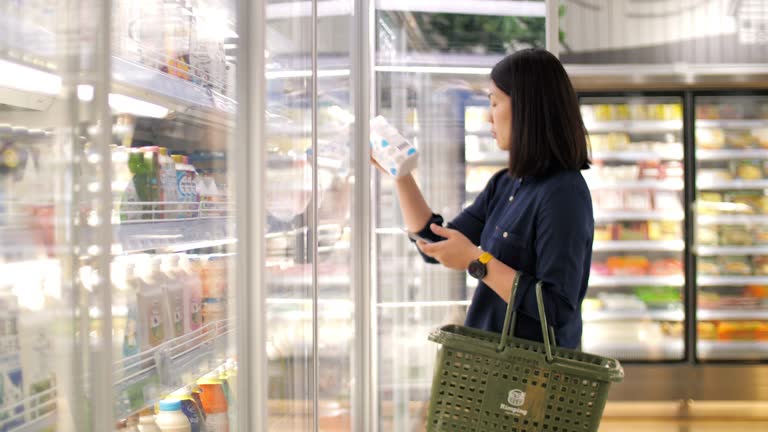 Woman take a fresh milk in supermarket , slow motion 4K(UHD)
