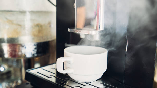 istock Coffee pouring from the machine to white cup 1125918771