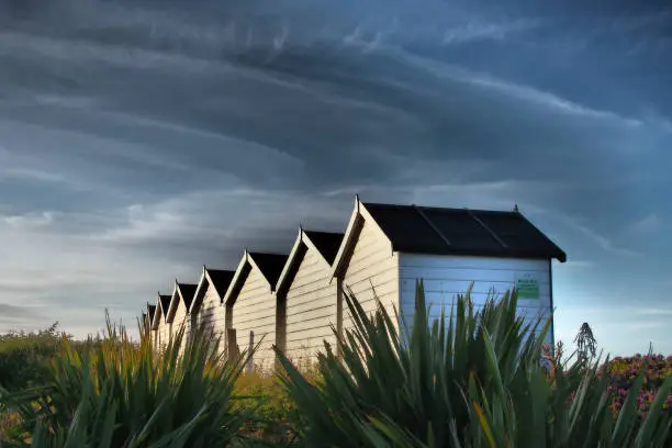 Photo of Beach huts with atmospheric sky