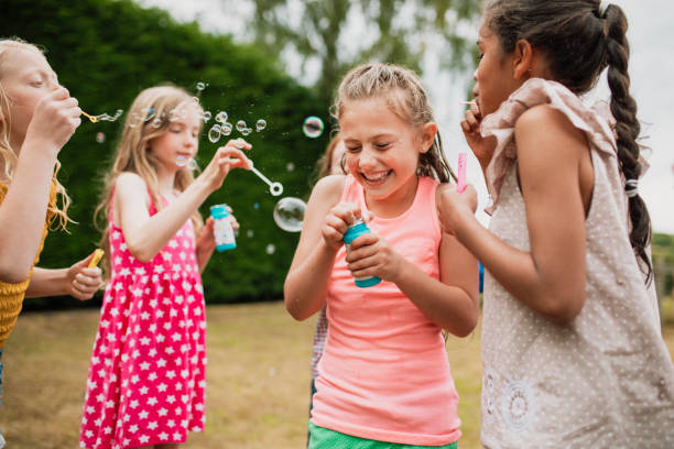 istock Young Girls Blowing Bubbles 1125920655