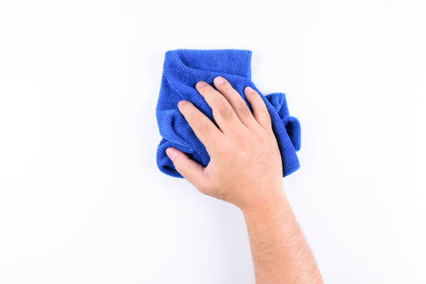 istock A man's hand holding blue microfiber rags cloth for wipe or cleaning on white background or isolated 1125920747