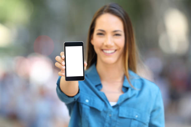 istock Happy woman showing smart phone mock up 1125922746