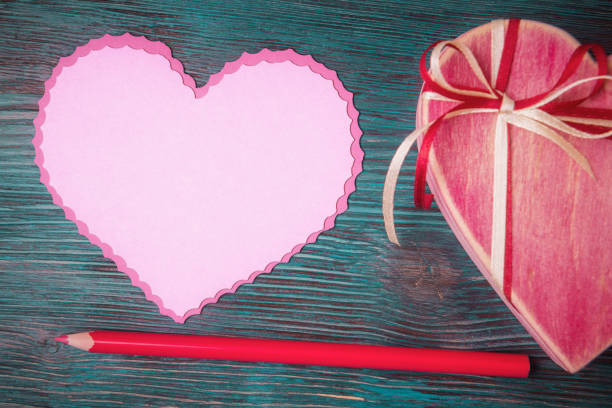 istock Blank heart shaped template with red pencil and gift box 1125924813