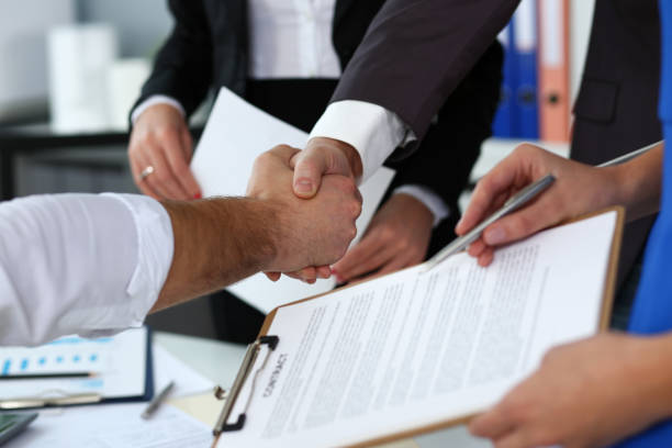 istock Man in suit and tie give hand as hello in office closeup 1125926539