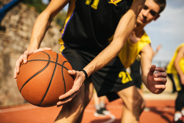 istock Ball for basket in human hands 1125926653