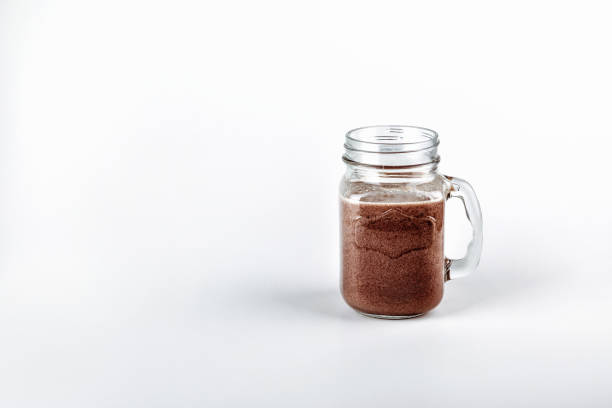 istock Fresh protein shake, milk with cocoa in a glass jar on a white background 1125930049