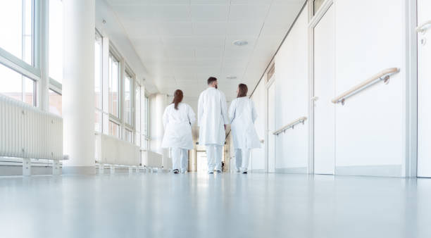 istock Three doctors walking down a corridor in hospital 1125932579