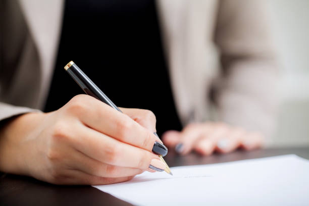 istock Contract Signature. Business Woman Signing Contract Document Form 1125933879