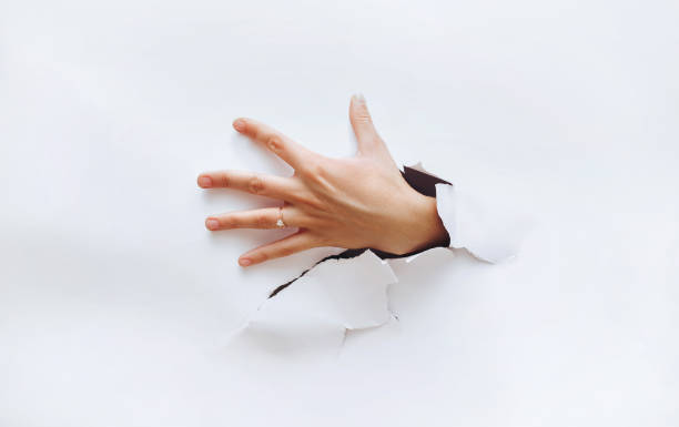 A hand breaks through the obstacle and tries to grab something. Secret desire. A hand breaks through the obstacle and tries to grab something. Secret desire. Stealing. left handed catcher stock pictures, royalty-free photos & images