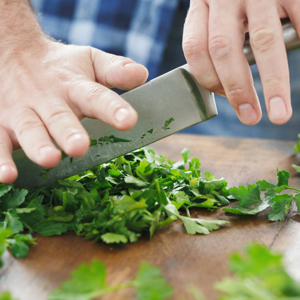 istock male hands chopped parsley 1125937816