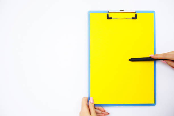 istock Blank Folder with Yellow Paper. Hand that Holding Folder and Handle on White Background. Copyspace. Place for Text 1125937937