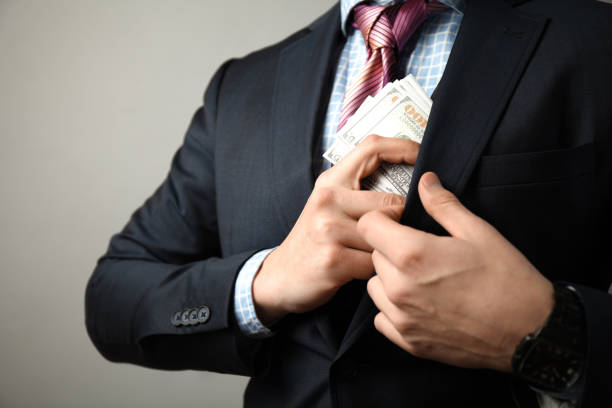 istock Giving bribe to official, man in suit is corrupt 1125939423
