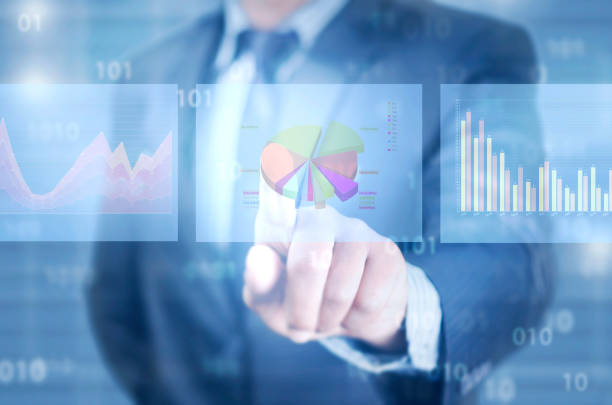 istock Finger pointing on virtual screen of financial charts 1125939483
