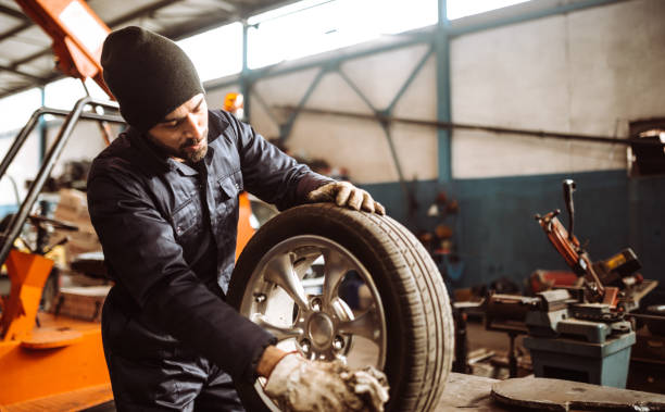 istock mechanic man repair a tire 1125939779
