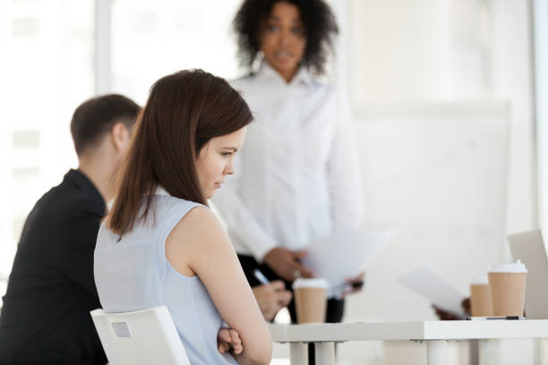 Young worker feels offended frustrated during meeting at work Diverse businesspeople in office during briefing focus on female worker feels guilty unhappy offended and frustrated having problem or disrespect from colleagues or made mistake, listens boss scolding cruel stock pictures, royalty-free photos & images