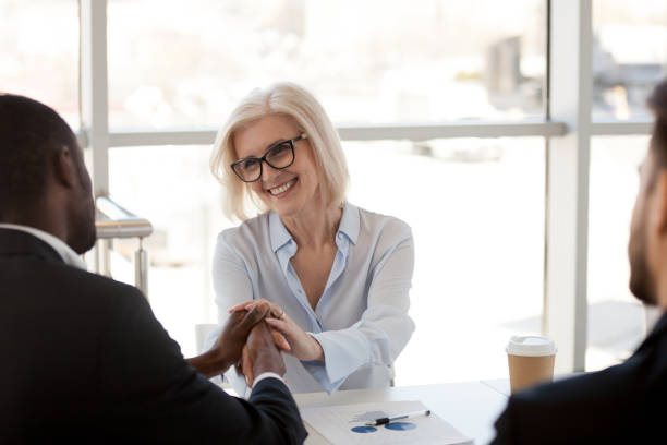 istock Mature team leader shaking hands with black businessman 1125941778