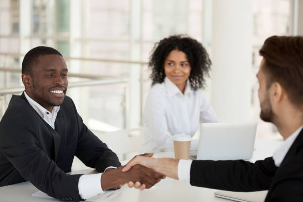 istock Diverse partners greeting each other in meeting shaking hands 1125941852