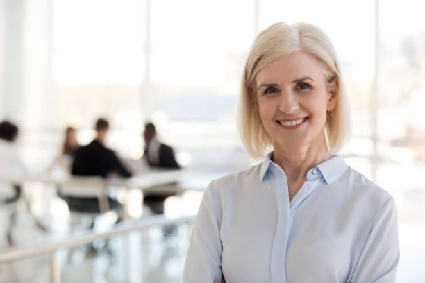 istock Happy successful aged business lady posing looking at camera 1125941884