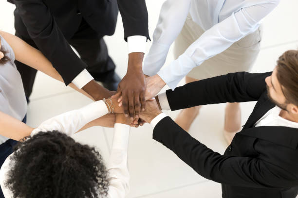 istock Top above view diverse business people stacked hands 1125942571