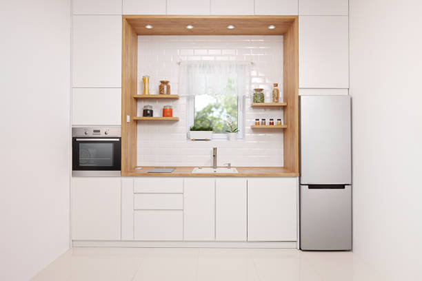 istock Stylish kitchen interior in white and wood with a window view 1125942618