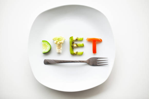 istock Diet or weight control concept. Centimeter tape and fork on a white background with a place for inserting text. concept of health, weight loss, diet, proper nutrition 1125943096