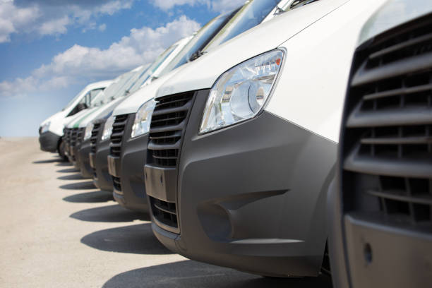 istock White mini-buses in a row for sale or rent. 1125943213