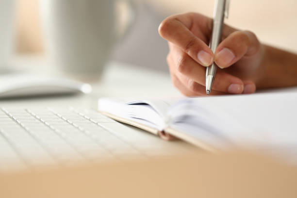 istock Female hand holding silver pen ready to make 1125943387