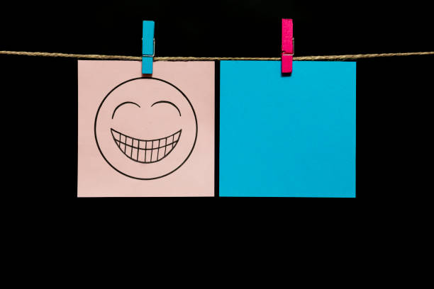 istock Copy space. Two stickers. On gray page on the face is an expression of gaiety. 1125944511
