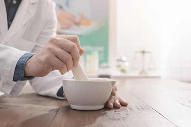 istock Professional pharmacist grinding a medical preparation using a mortar and pestle, pharmacy and medicine concept, hands close up 1125944949