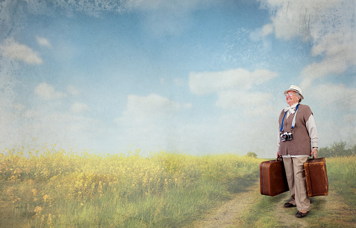 senior woman with suitcase dreaming of her dream vacation, concept time of retirement is the time to travel