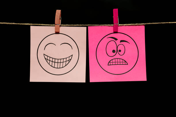 istock Copy space. Two multi-colored stickers with emoticons. Joy. Rage. Positive and negative. 1125946935