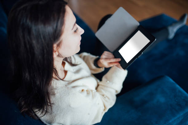 Woman reading e book at home