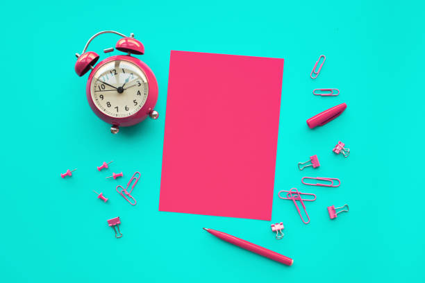 Performance concepts with paper,pencil and alarm clock on worktable background.Time and dateline