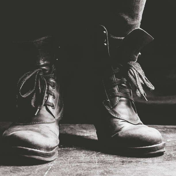 istock Female legs shod in old Hiking boots 1125948057