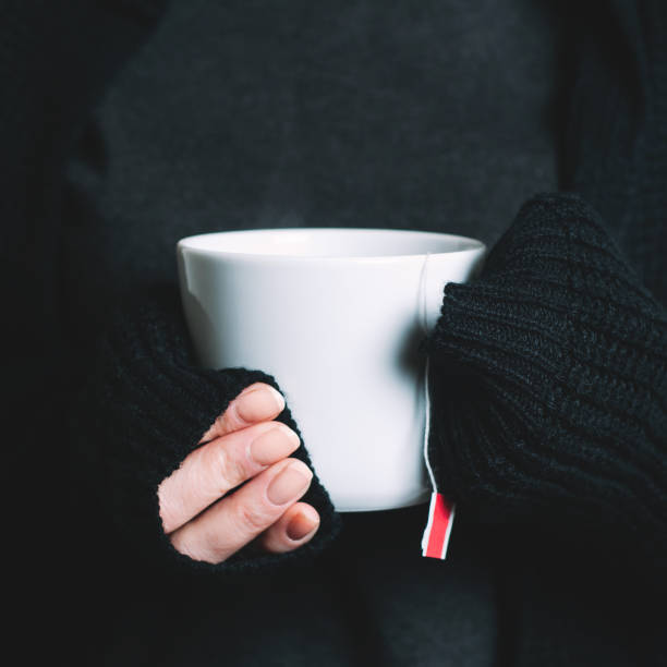 istock Woman holding a cup of red tea in her hands 1125948064
