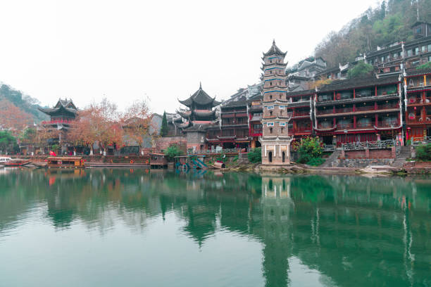 FENGHUANG, HUNAN, CHINA - DECEMBER 12 2018 : View of the Pagoda by the Tuojiang River (Tuo Jiang River) in Phoenix Ancient Town (Fenghuang County), China. Fenghuang is a popular tourist destination of Asia.