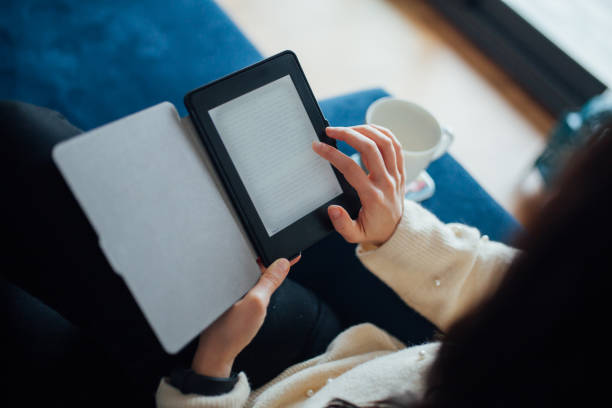 istock Woman reading e book at home 1125950594