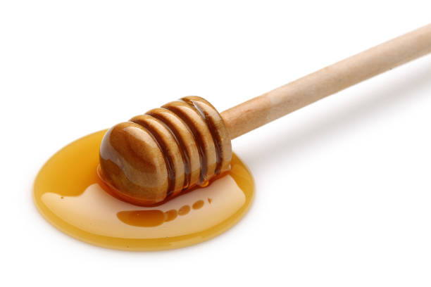 istock Wooden stick in the honey puddle 1125951379