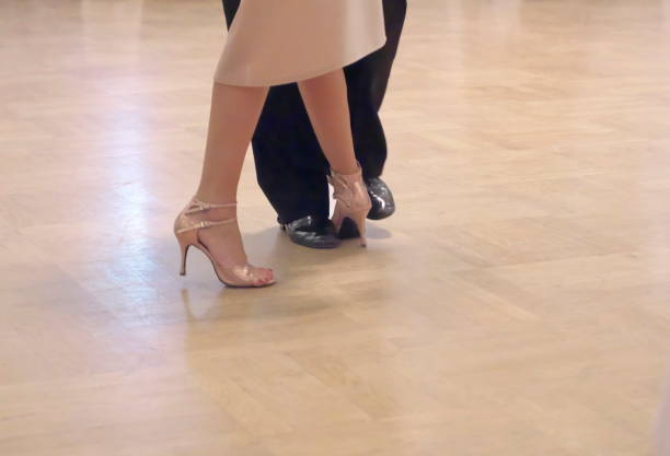 istock Graceful dance couple tangoing at the ballroom. 1125951810