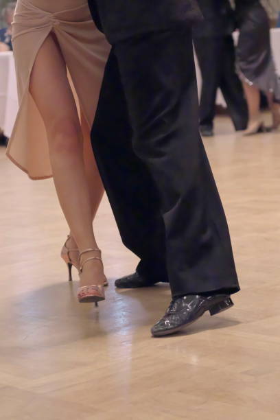 istock Graceful dance couple tangoing at the ballroom. 1125951918