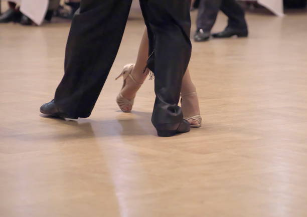 istock Graceful dance couple tangoing at the ballroom. 1125952513