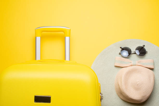 istock The flat lay a yellow suitcase with accessories for relaxing on a yellow background. concept of travel, rest and relaxation 1125954314
