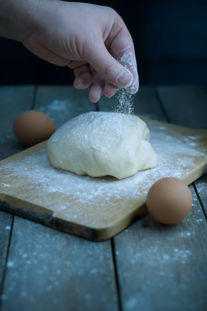 istock The male hand is sprinkling with flour 1125954623