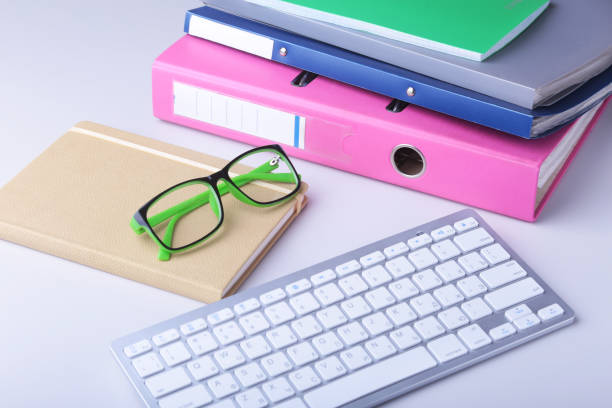 istock Office desk table with blank notebook, keyboard, other supplies and coffee cup. Top view with copy space 1125955634