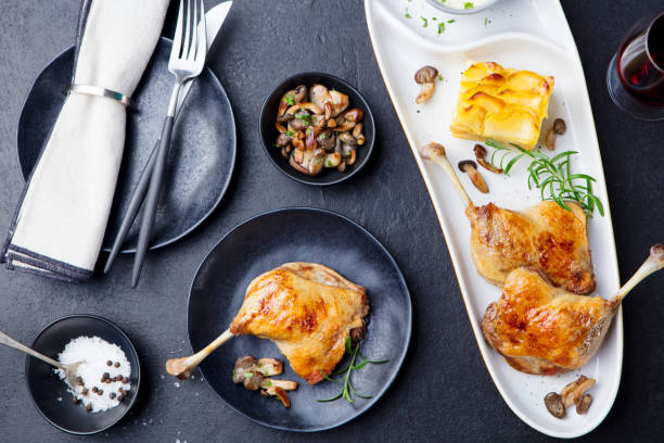 istock Duck legs confit with potato gratin and mushroom sauce. Restaurant serving. Top view. 1125957783