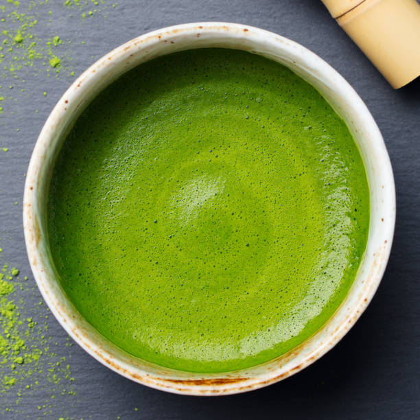 Matcha, green tea latte in a cup. Grey stone background. Top view. Matcha, green tea latte in a cup. Grey stone background. Top view matcha tea stock pictures, royalty-free photos & images