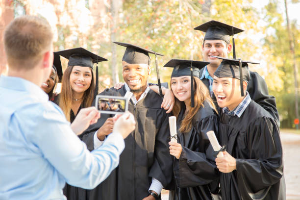 istock College students and father after graduation ceremony. 1125958177
