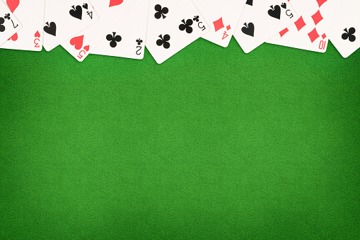 Cards on green felt casino table background