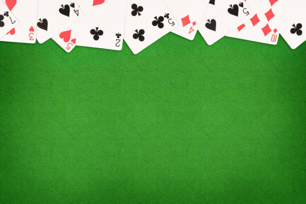 Cards on green felt casino table background Cards on green felt casino table background. Template with copy space in center poker card game stock pictures, royalty-free photos & images