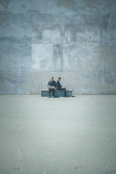 istock wireless working twins with laptop in urban surrounding 1125959750